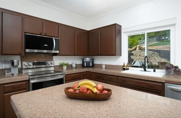 a kitchen with a sink a stove and a microwave
