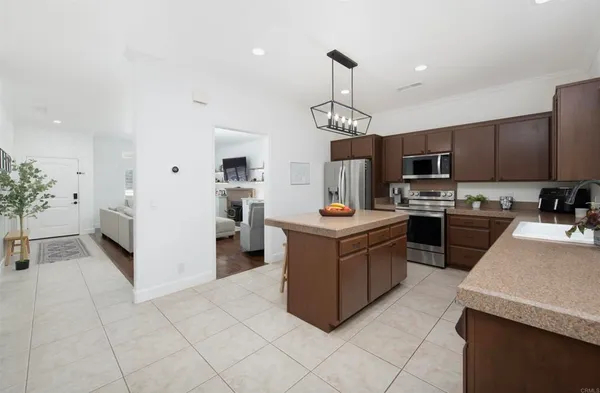 a kitchen with a sink a counter top space appliances and cabinets