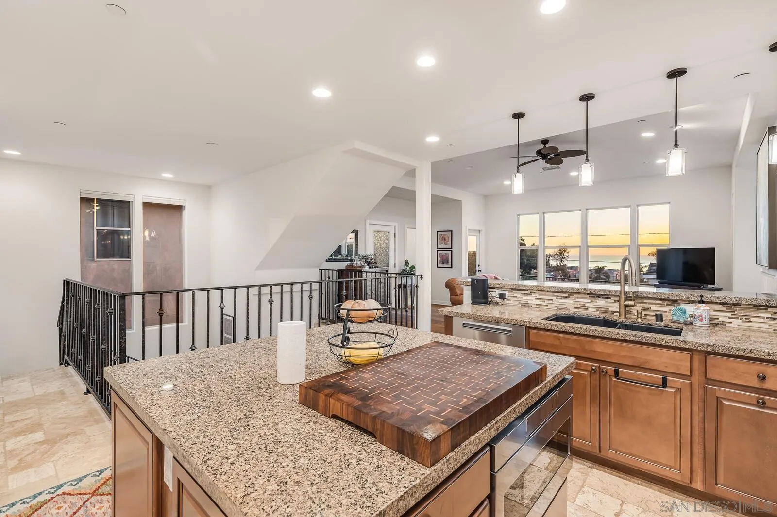 2009 MacKinnon Avenue Cardiff, CA 92007 - Photo 1 of 54 a kitchen with a stove a sink dishwasher a kitchen island with wooden cabinets and floor