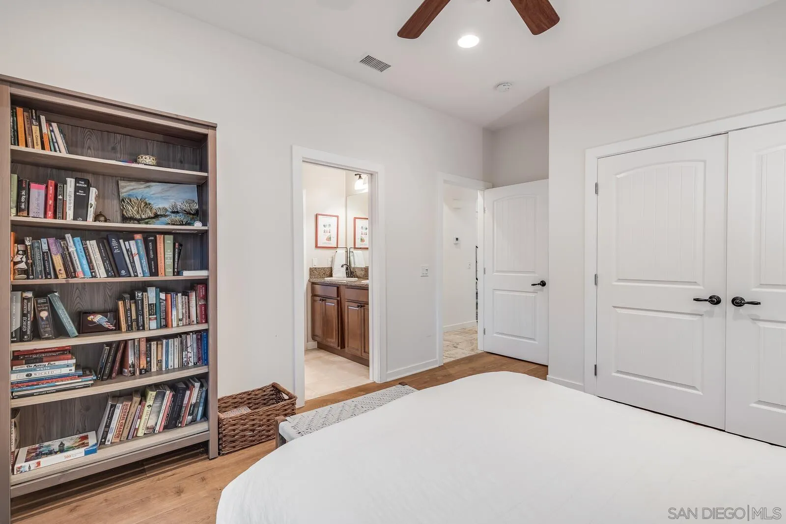 2009 MacKinnon Avenue Cardiff, CA 92007 - Photo 27 of 54 a bedroom with a bed and a book shelf