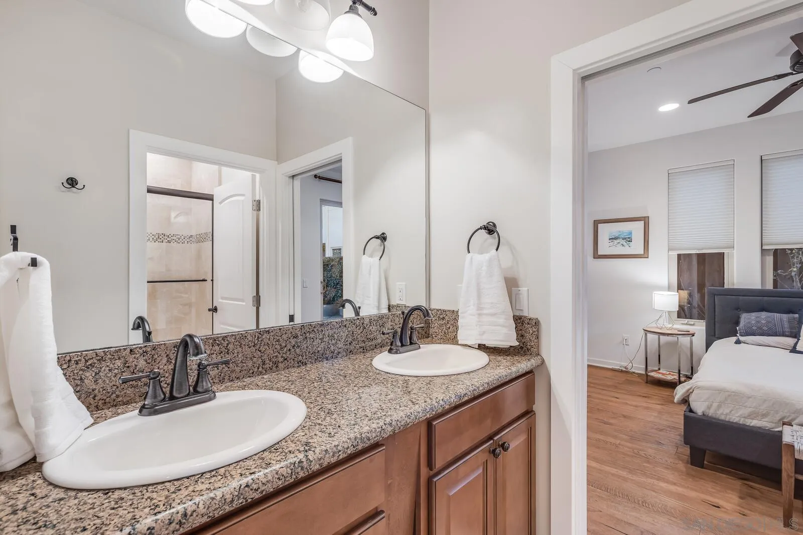 2009 MacKinnon Avenue Cardiff, CA 92007 - Photo 28 of 54 a bathroom with a granite countertop sink a mirror and a vanity