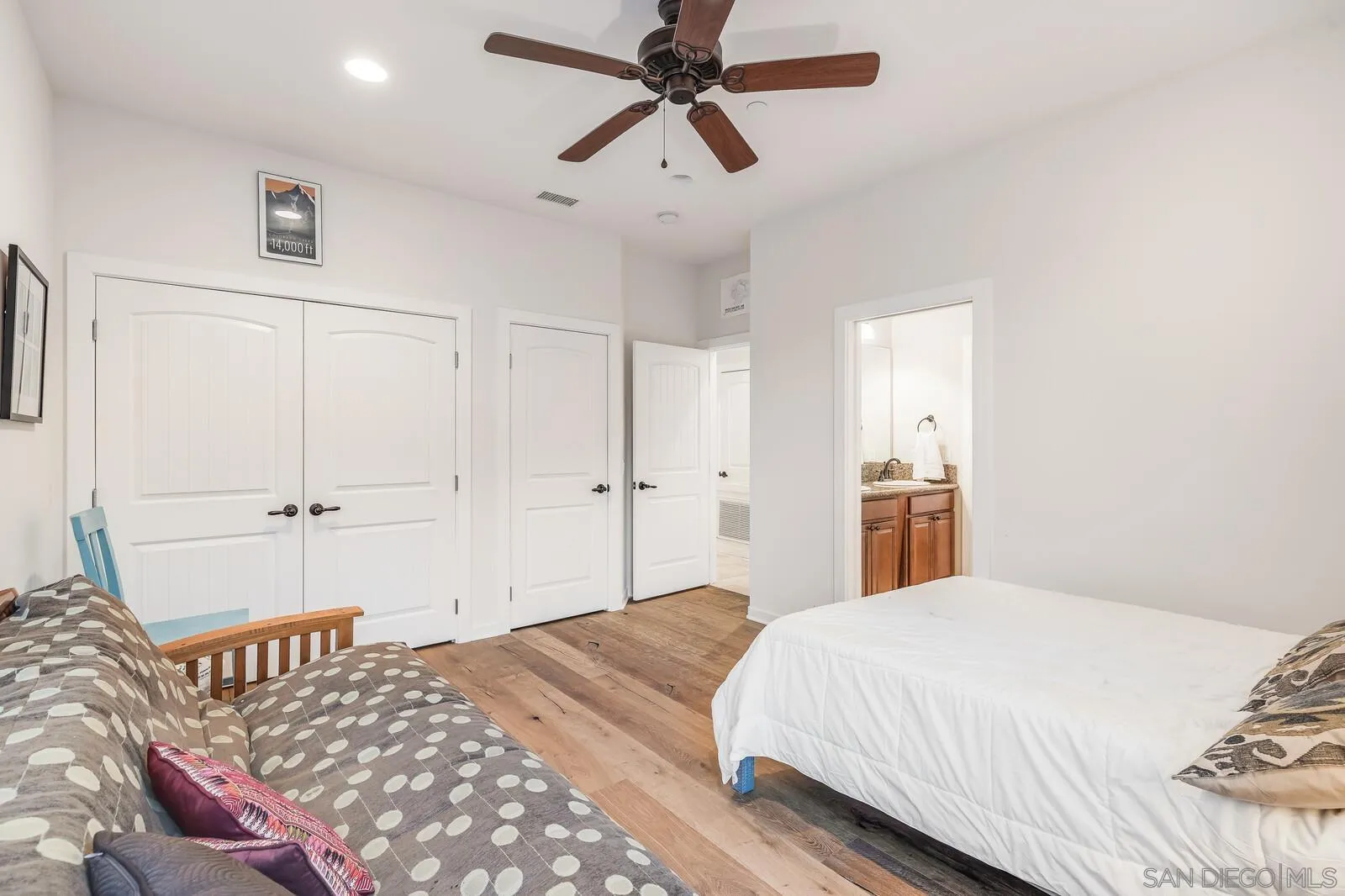 2009 MacKinnon Avenue Cardiff, CA 92007 - Photo 31 of 54 a bedroom with a bed and a chandelier