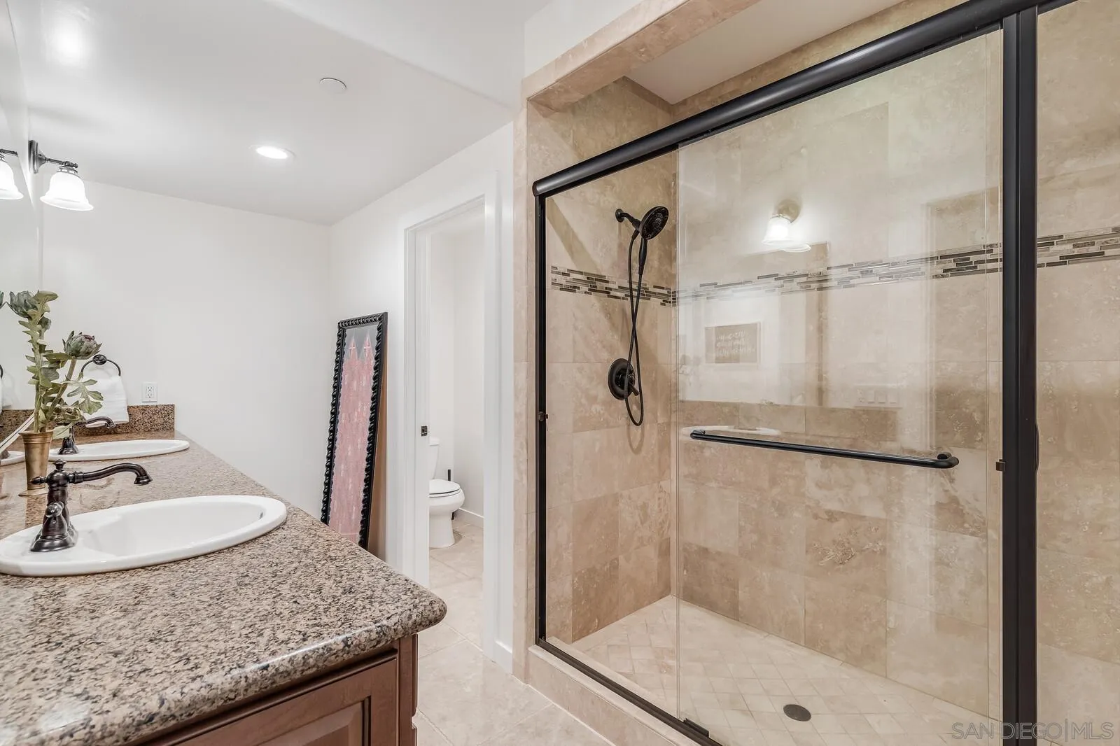 2009 MacKinnon Avenue Cardiff, CA 92007 - Photo 34 of 54 a bathroom with a granite countertop shower sink and mirror