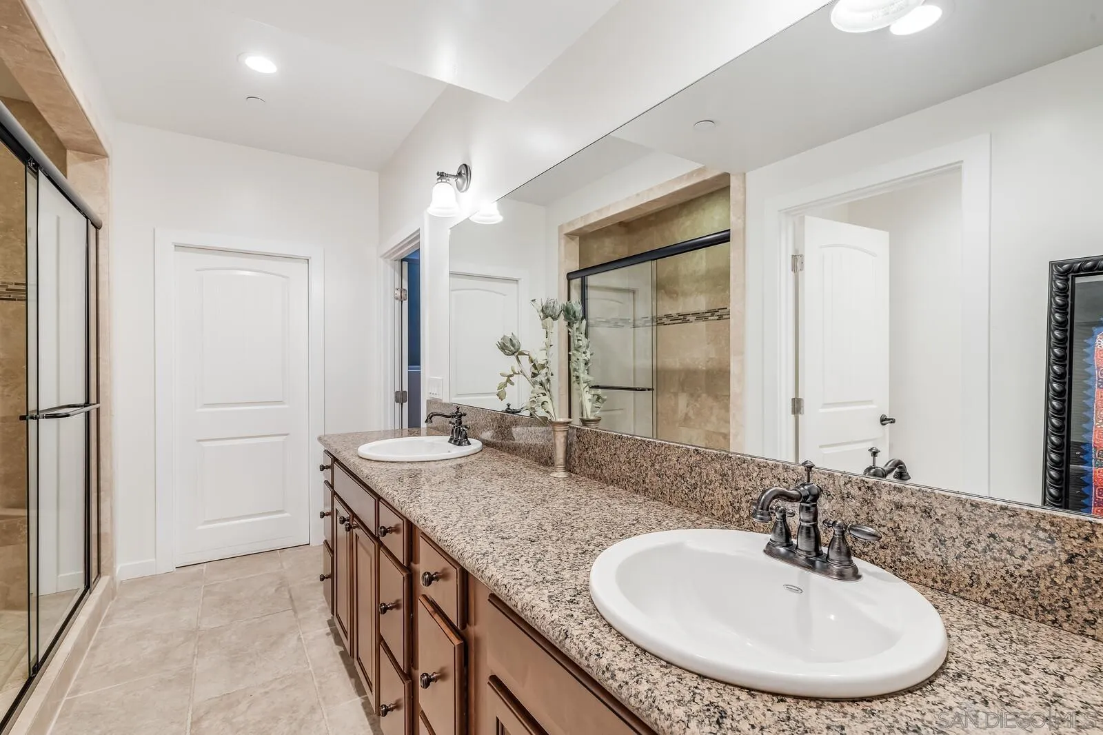 2009 MacKinnon Avenue Cardiff, CA 92007 - Photo 35 of 54 a bathroom with a granite countertop sink and a mirror