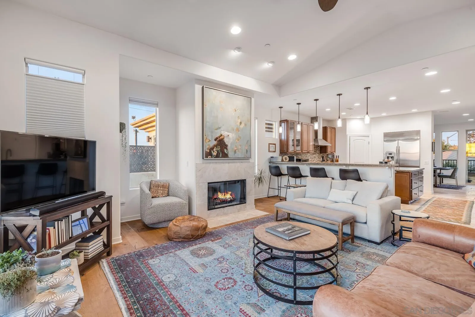 2009 MacKinnon Avenue Cardiff, CA 92007 - Photo 8 of 54 a living room with furniture a flat screen tv and a fireplace