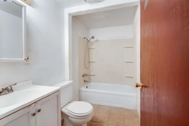 a bathroom with a sink toilet vanity and shower