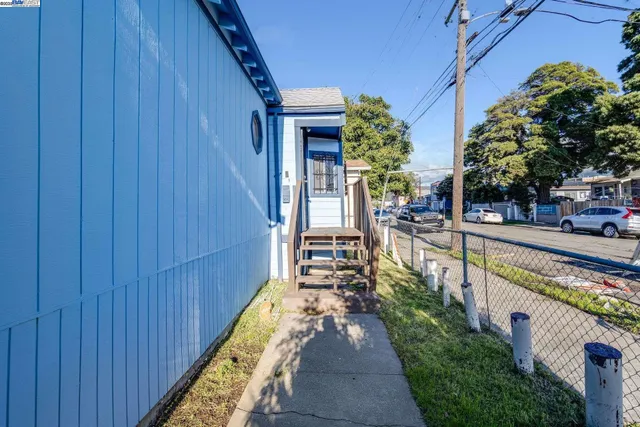 a view of a patio with chairs and potted plants