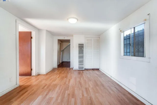 wooden floor in an empty room with a window