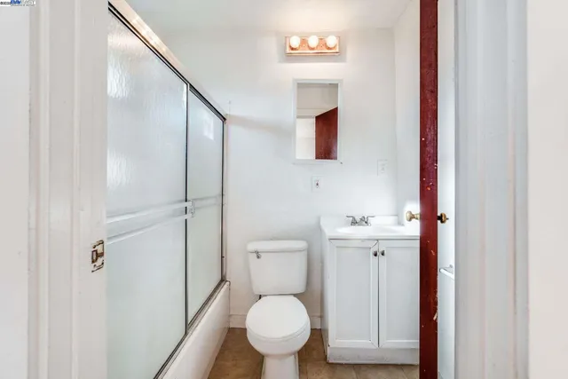 a white toilet sitting next to a bathroom sink