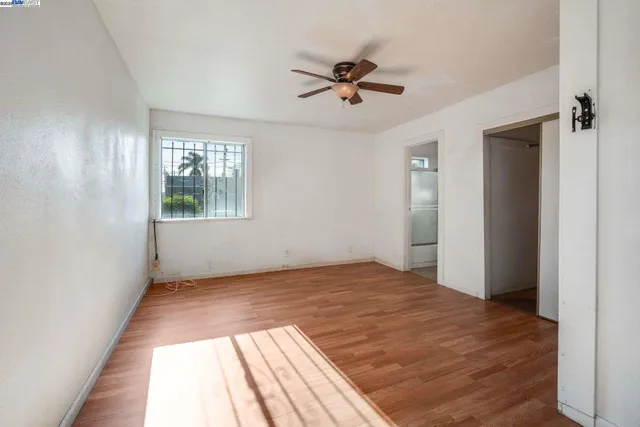 a view of a livingroom with a window and wooden floor
