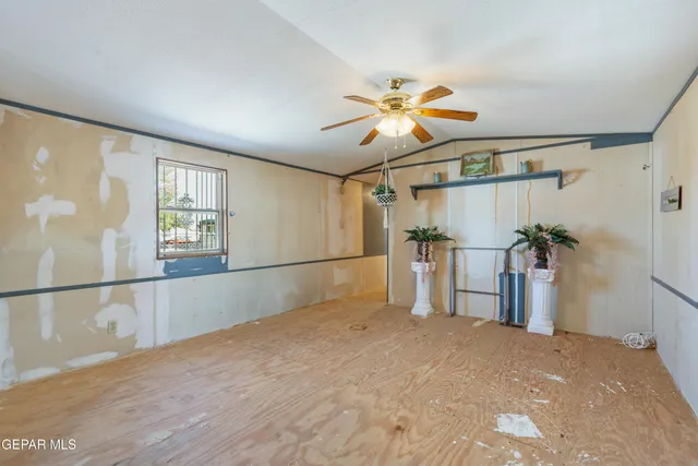 a view of a livingroom with a ceiling fan and wooden floor