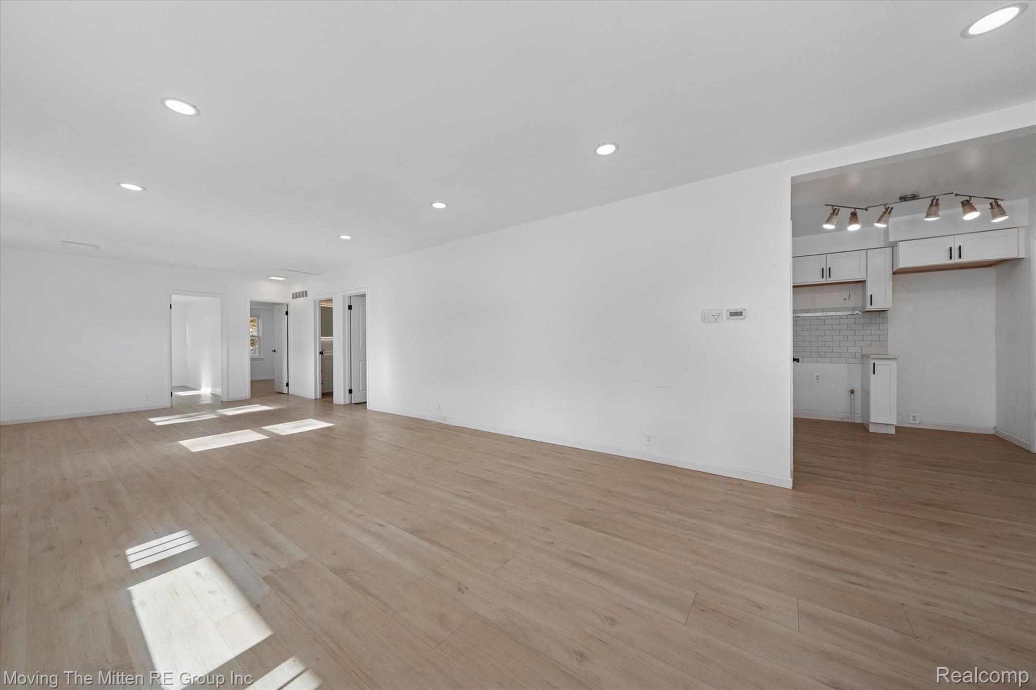 41190 Savage Road Belleville, MI 48111 - Photo 7 of 38 Unfurnished living room with recessed lighting and light wood-style flooring