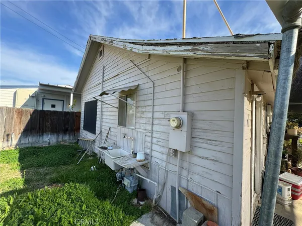 a backyard of a house with table and chairs