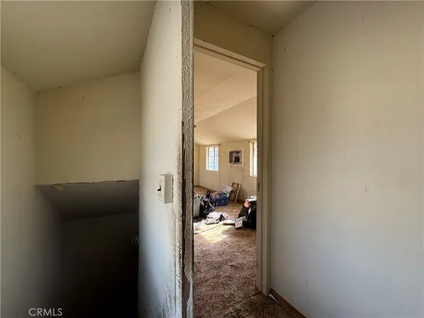 a view of a hallway with living room