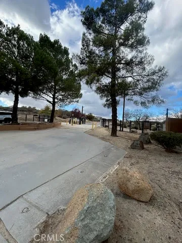 a view of a patio with table and chairs potted plants