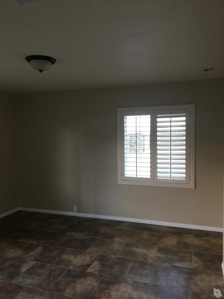 1582 Teal Club Road Oxnard, CA 93030 - Photo 8 of 8 a view of an empty room with wooden floor and a window