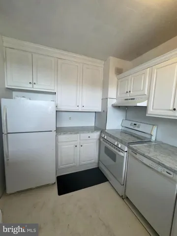 a kitchen with cabinets appliances and a counter space