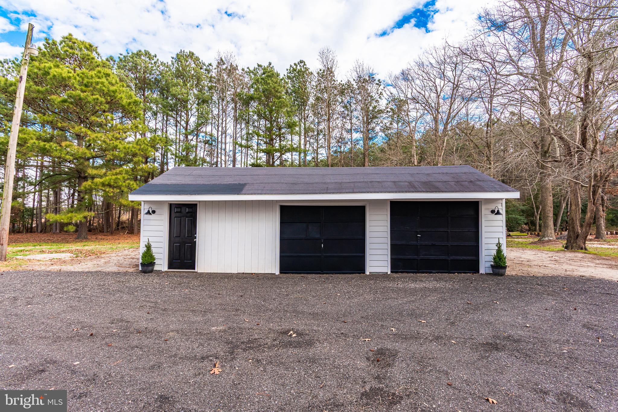 1745 Buck Harbor Road Pocomoke City, MD 21851 - Photo 2 of 29 a view of a house with a yard and garage