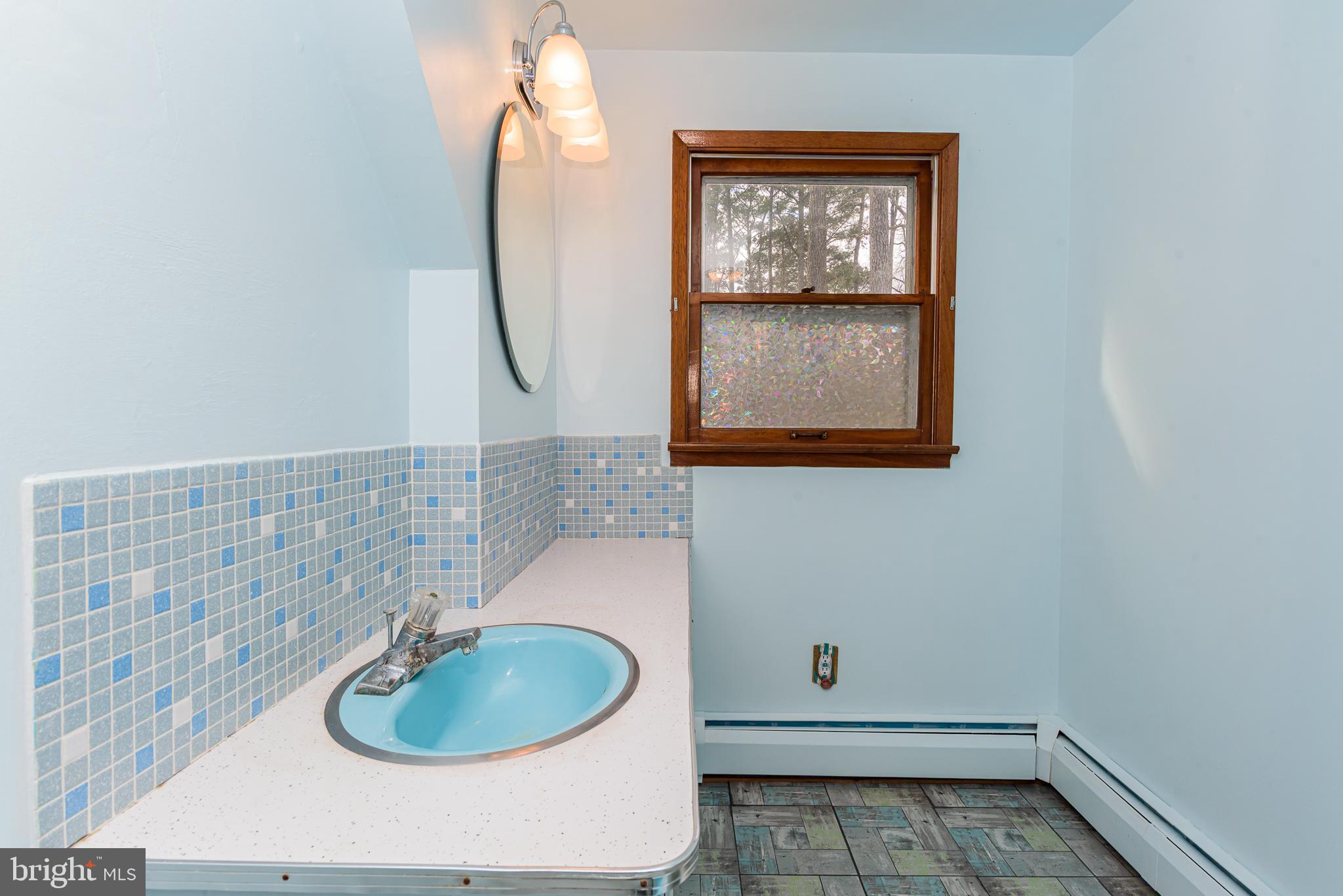 1745 Buck Harbor Road Pocomoke City, MD 21851 - Photo 24 of 29 a bathroom with a sink and a mirror
