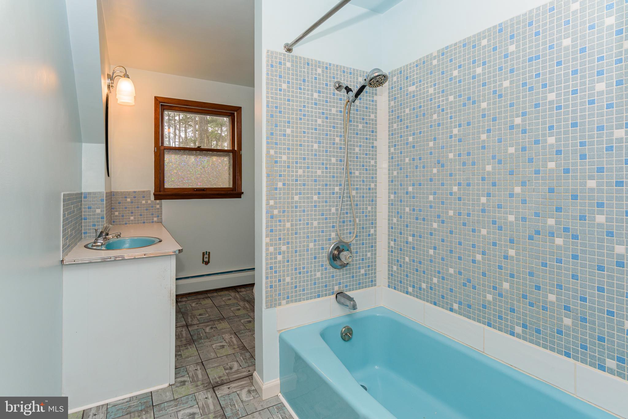 1745 Buck Harbor Road Pocomoke City, MD 21851 - Photo 25 of 29 a bathroom with a bathtub and a sink