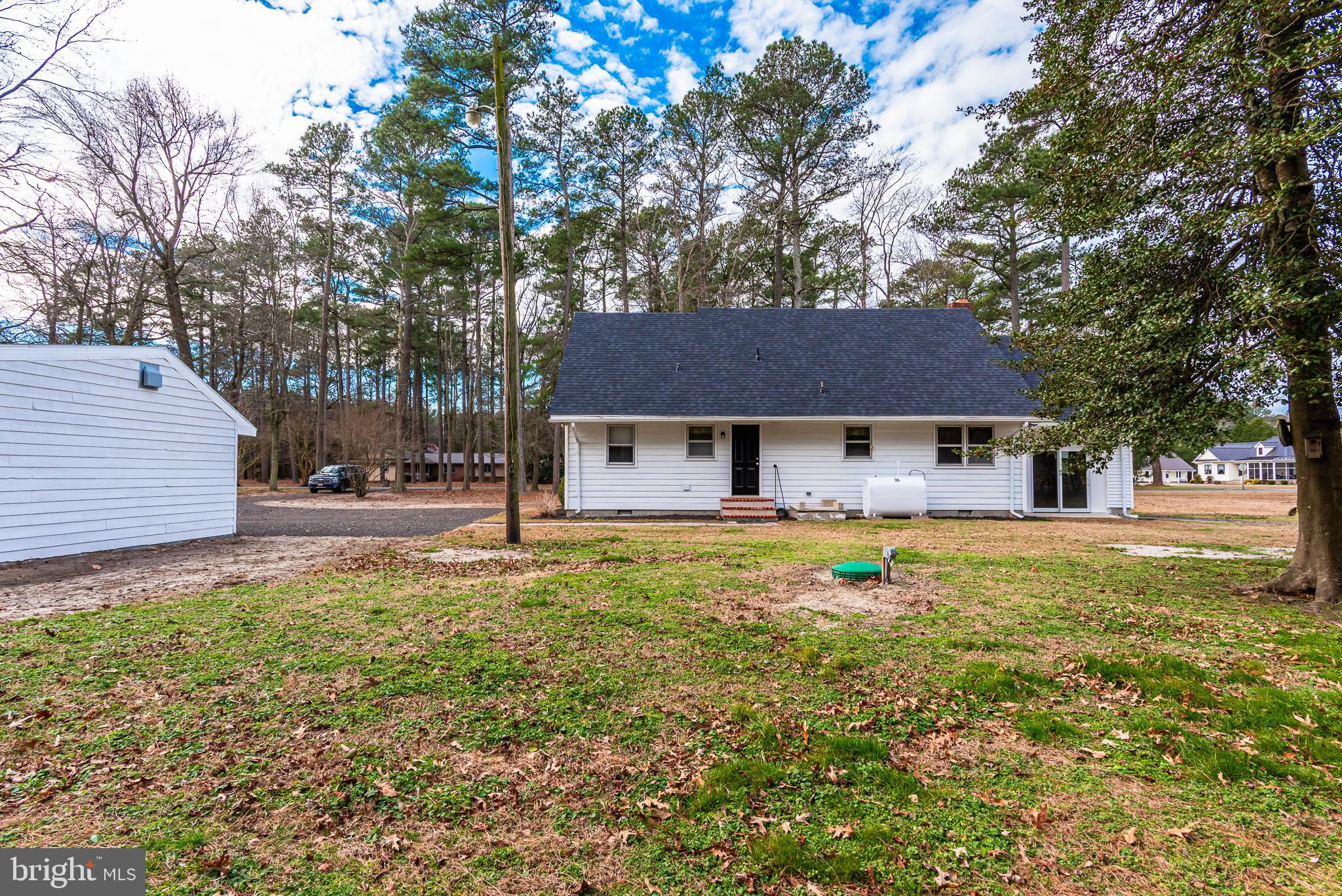 1745 Buck Harbor Road Pocomoke City, MD 21851 - Photo 3 of 29 a front view of a house with yard and trees