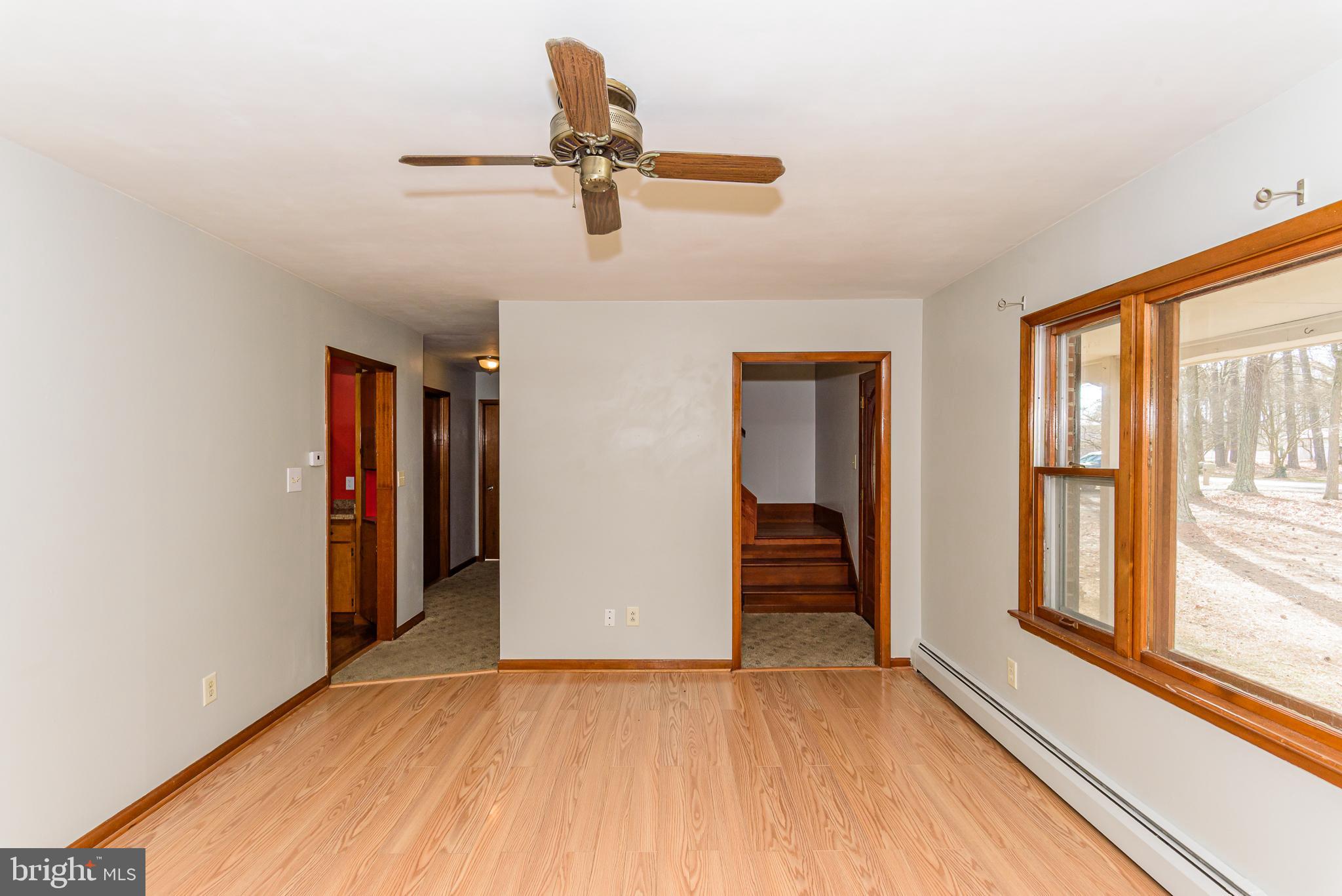 1745 Buck Harbor Road Pocomoke City, MD 21851 - Photo 7 of 29 wooden floor in an empty room with a window