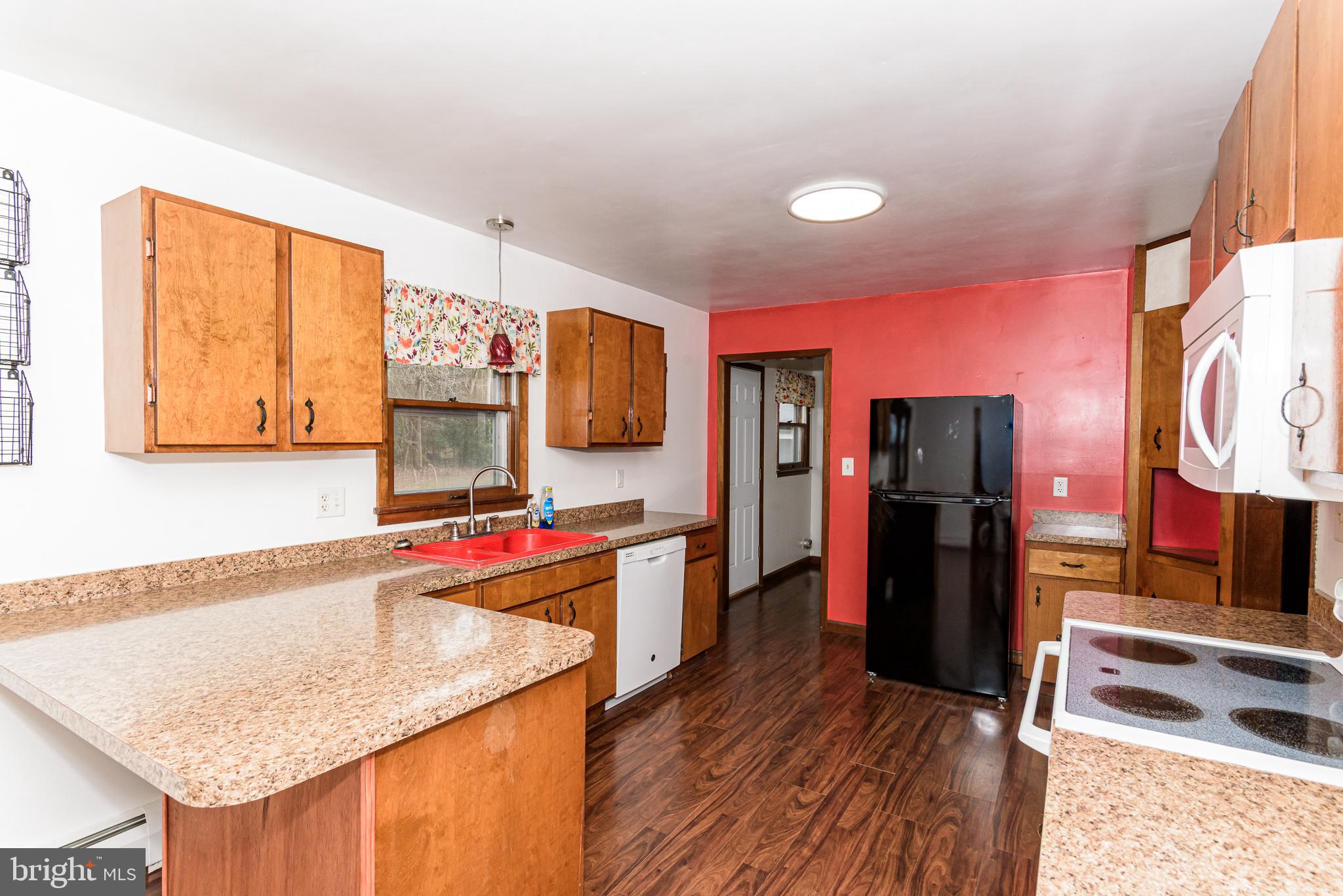 1745 Buck Harbor Road Pocomoke City, MD 21851 - Photo 10 of 29 a kitchen that has a sink and a wooden floor