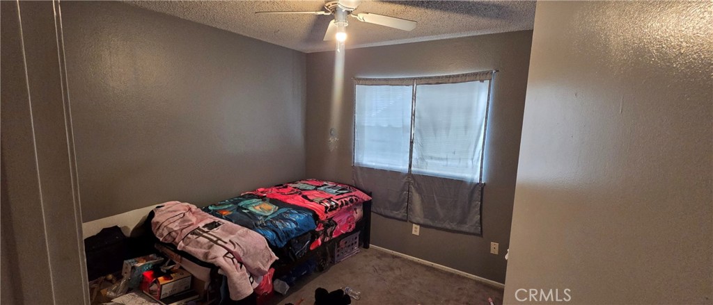 1548 Ranch Road San Bernardino, CA 92407 - Photo 11 of 26 a bedroom with a bed and a window