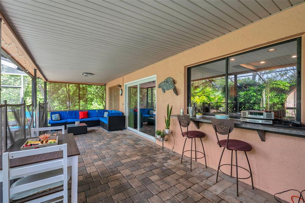 11334 Redgate Street Spring Hill, FL 34609 - Photo 13 of 67 a living room with patio furniture and a wooden floor