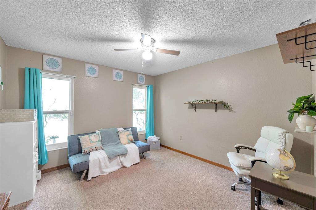 11334 Redgate Street Spring Hill, FL 34609 - Photo 14 of 67 a bed room with furniture and a chandelier