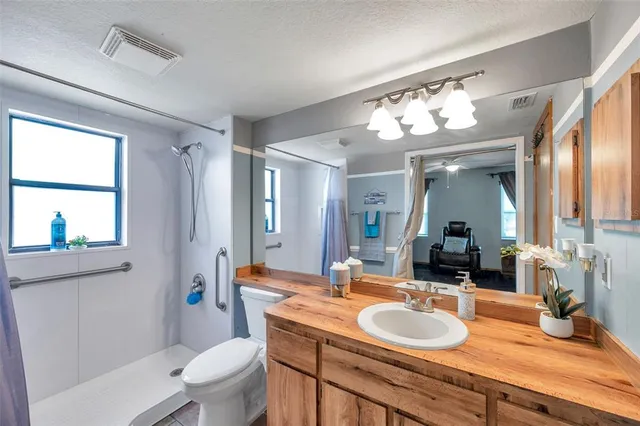 a backyard of a house with lots of green space and fountain