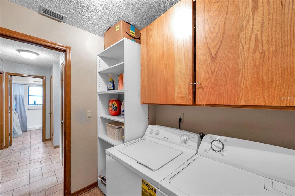 11334 Redgate Street Spring Hill, FL 34609 - Photo 17 of 67 a utility room with dryer and washer