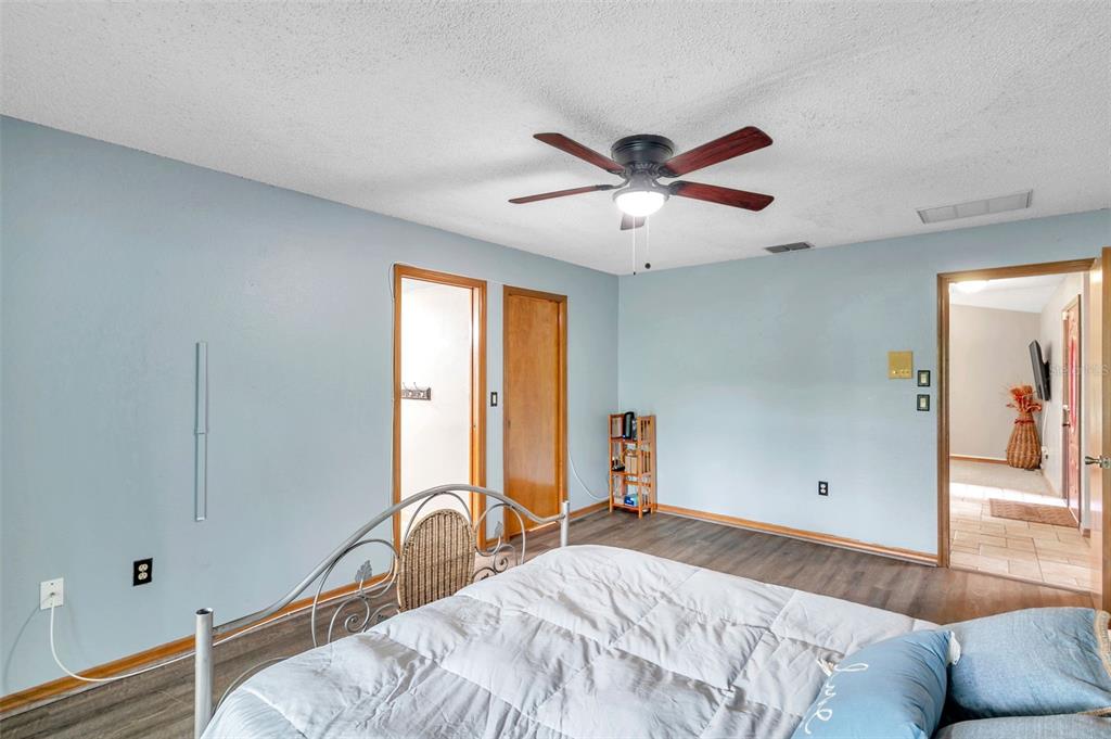 11334 Redgate Street Spring Hill, FL 34609 - Photo 30 of 67 a bedroom with a bed and a large window