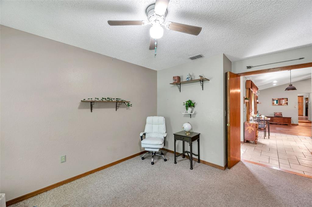 11334 Redgate Street Spring Hill, FL 34609 - Photo 38 of 67 a workspace with furniture and a chandelier fan