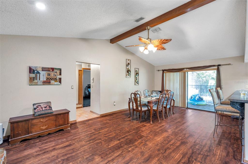 11334 Redgate Street Spring Hill, FL 34609 - Photo 46 of 67 a dining room with wooden floor and large window