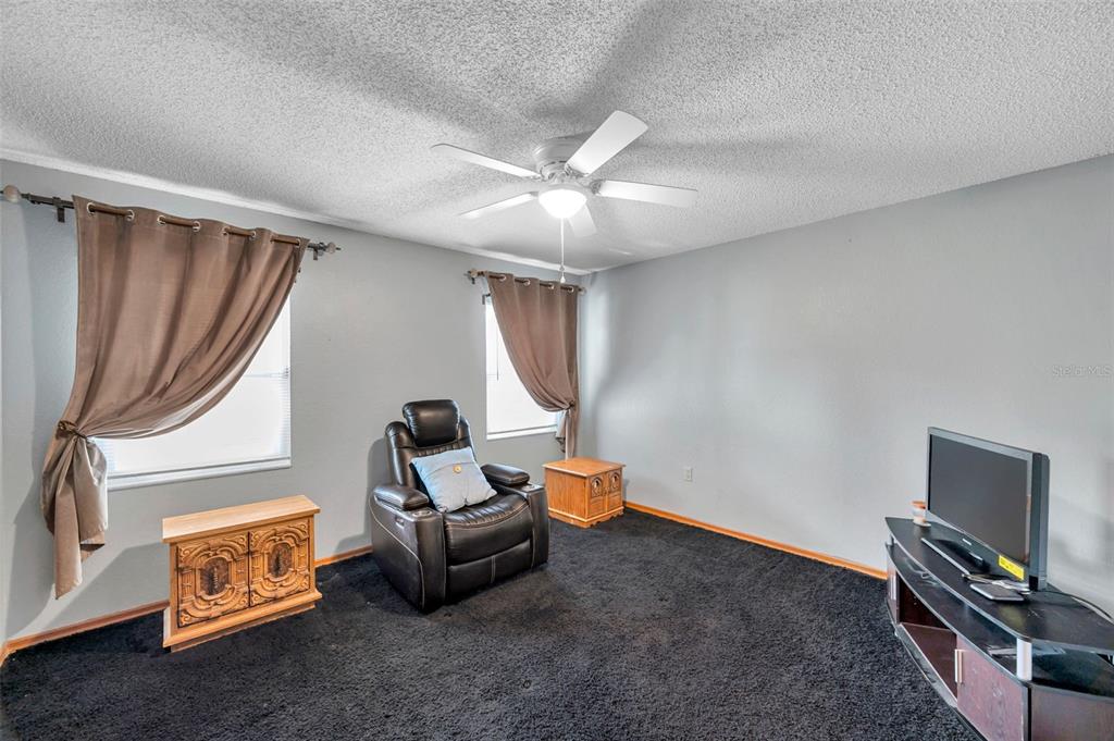 11334 Redgate Street Spring Hill, FL 34609 - Photo 48 of 67 a living room with furniture and a flat screen tv