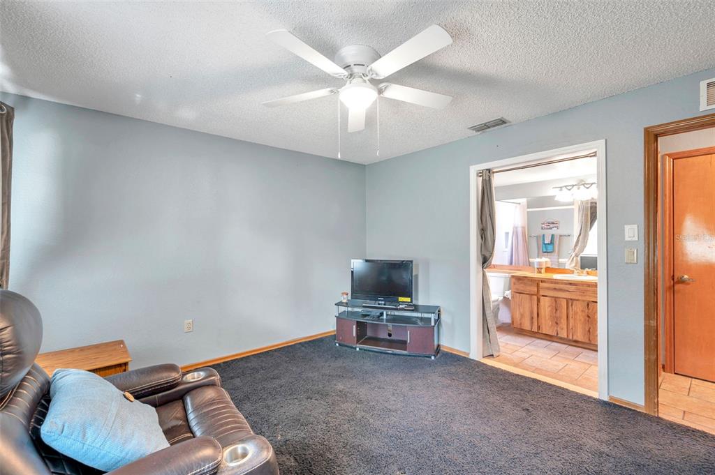 11334 Redgate Street Spring Hill, FL 34609 - Photo 49 of 67 a living room with furniture and a window