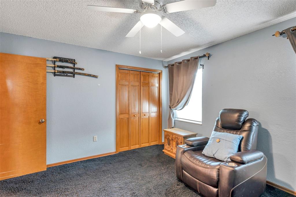 11334 Redgate Street Spring Hill, FL 34609 - Photo 50 of 67 a living room with furniture and a window