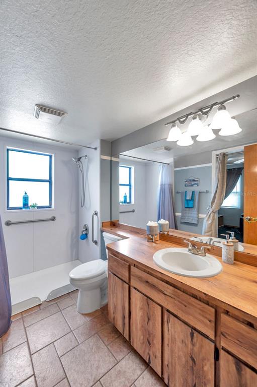 11334 Redgate Street Spring Hill, FL 34609 - Photo 54 of 67 a bathroom with a granite countertop sink mirror vanity and toilet