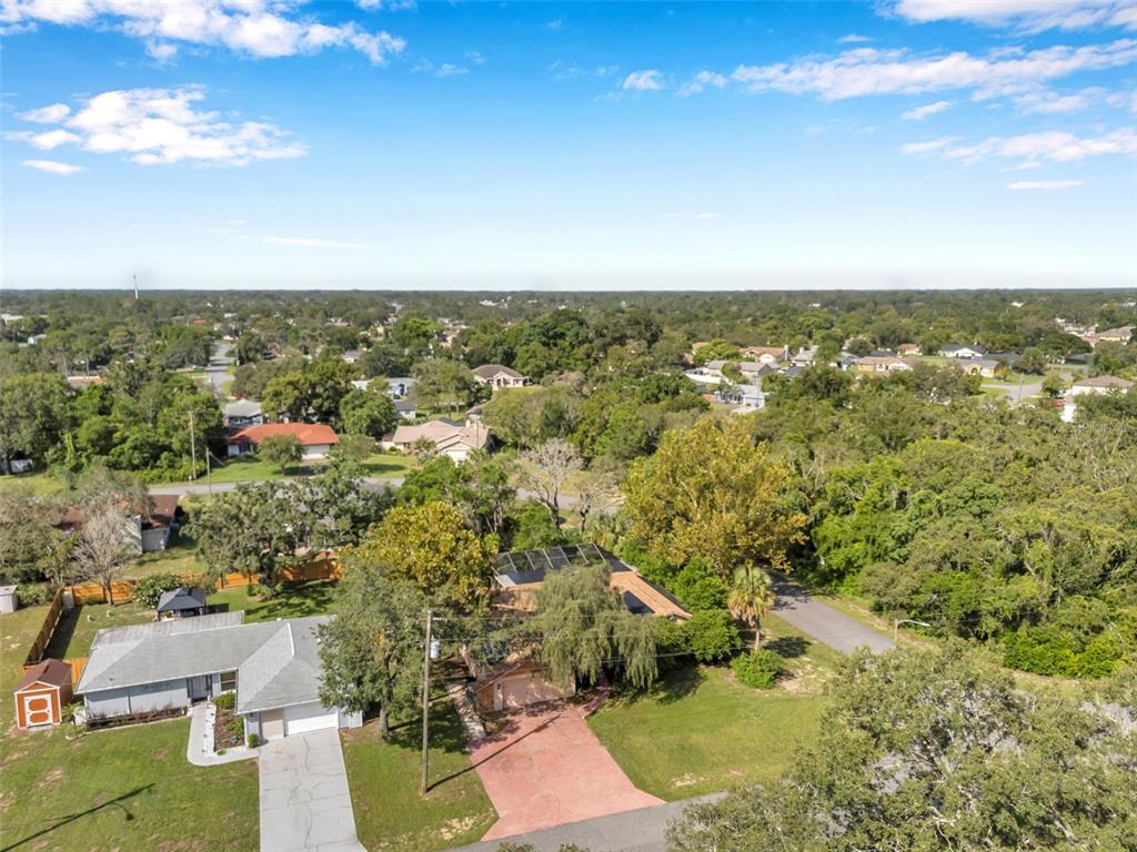 11334 Redgate Street Spring Hill, FL 34609 - Photo 63 of 67 an aerial view of residential houses with outdoor space and trees