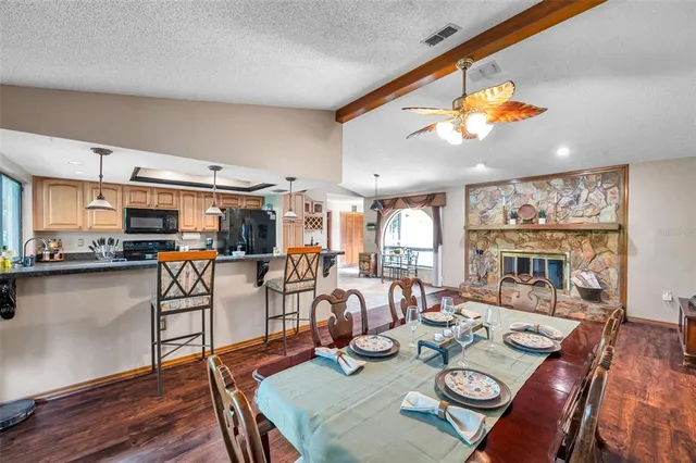 a living room with patio furniture and a wooden floor