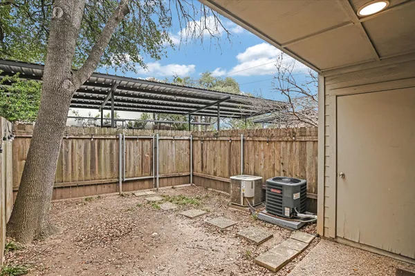 a view of backyard with wooden fence