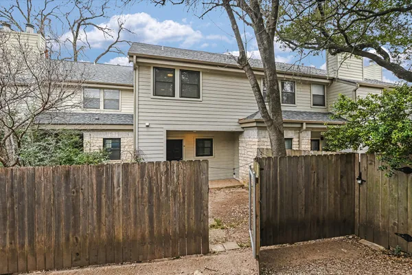 a front view of a house with a wooden fence