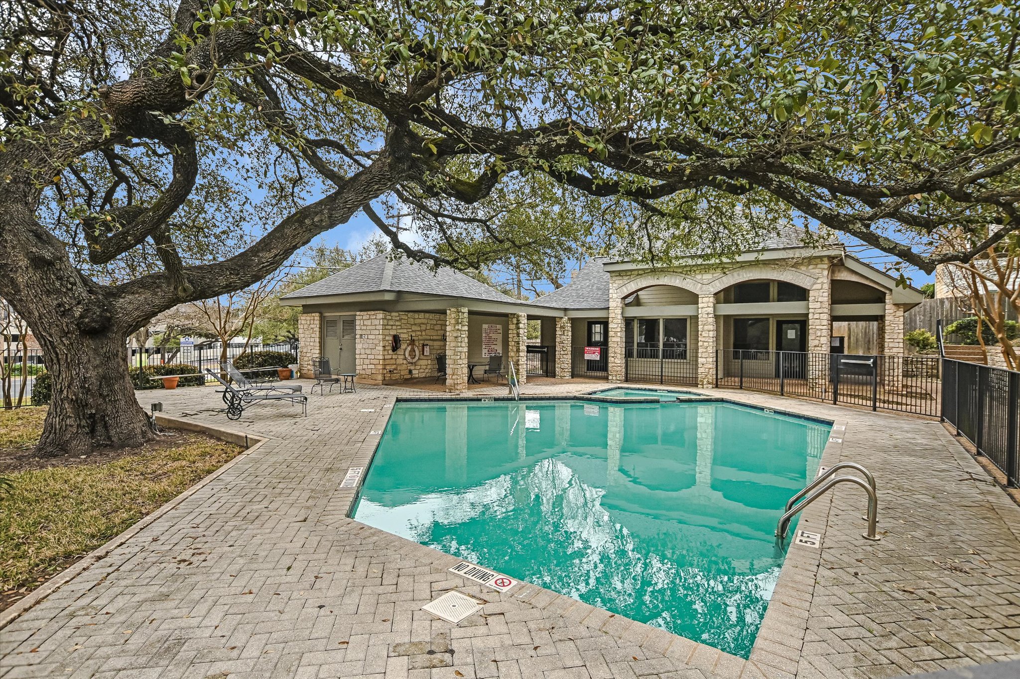 9226 Jollyville Road, Unit 122 Austin, TX 78759 - Photo 16 of 20 a front view of a house with a yard table and chairs