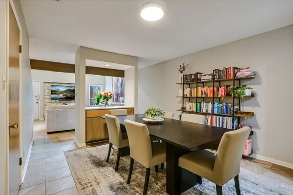 a view of a dining room with furniture and a book shelf