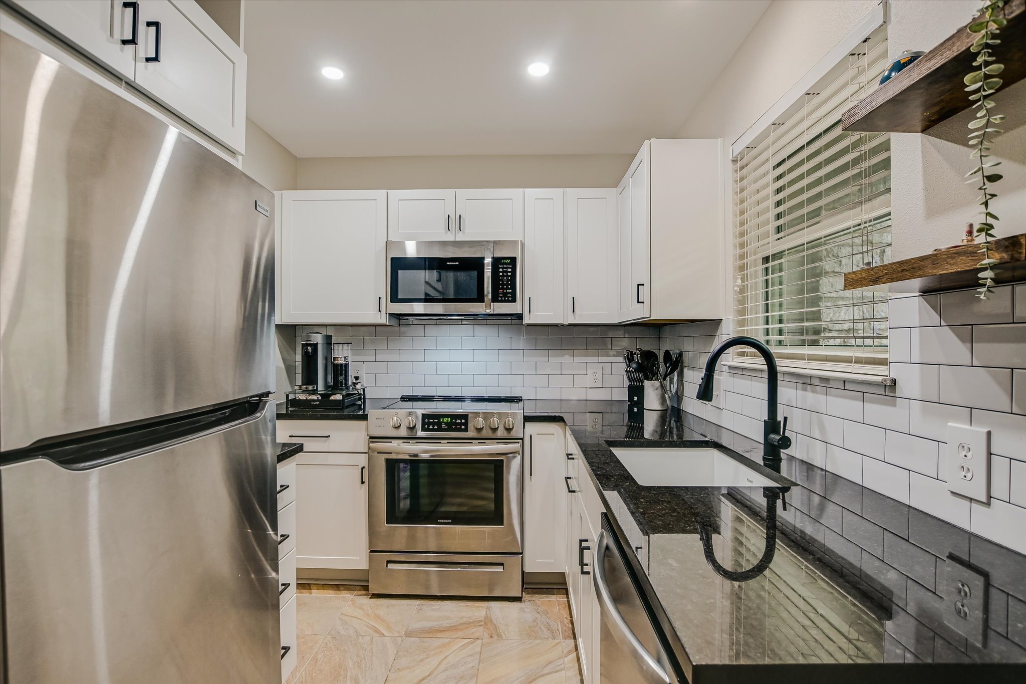 9226 Jollyville Road, Unit 122 Austin, TX 78759 - Photo 4 of 20 a kitchen with stainless steel appliances a sink a stove a refrigerator and cabinets