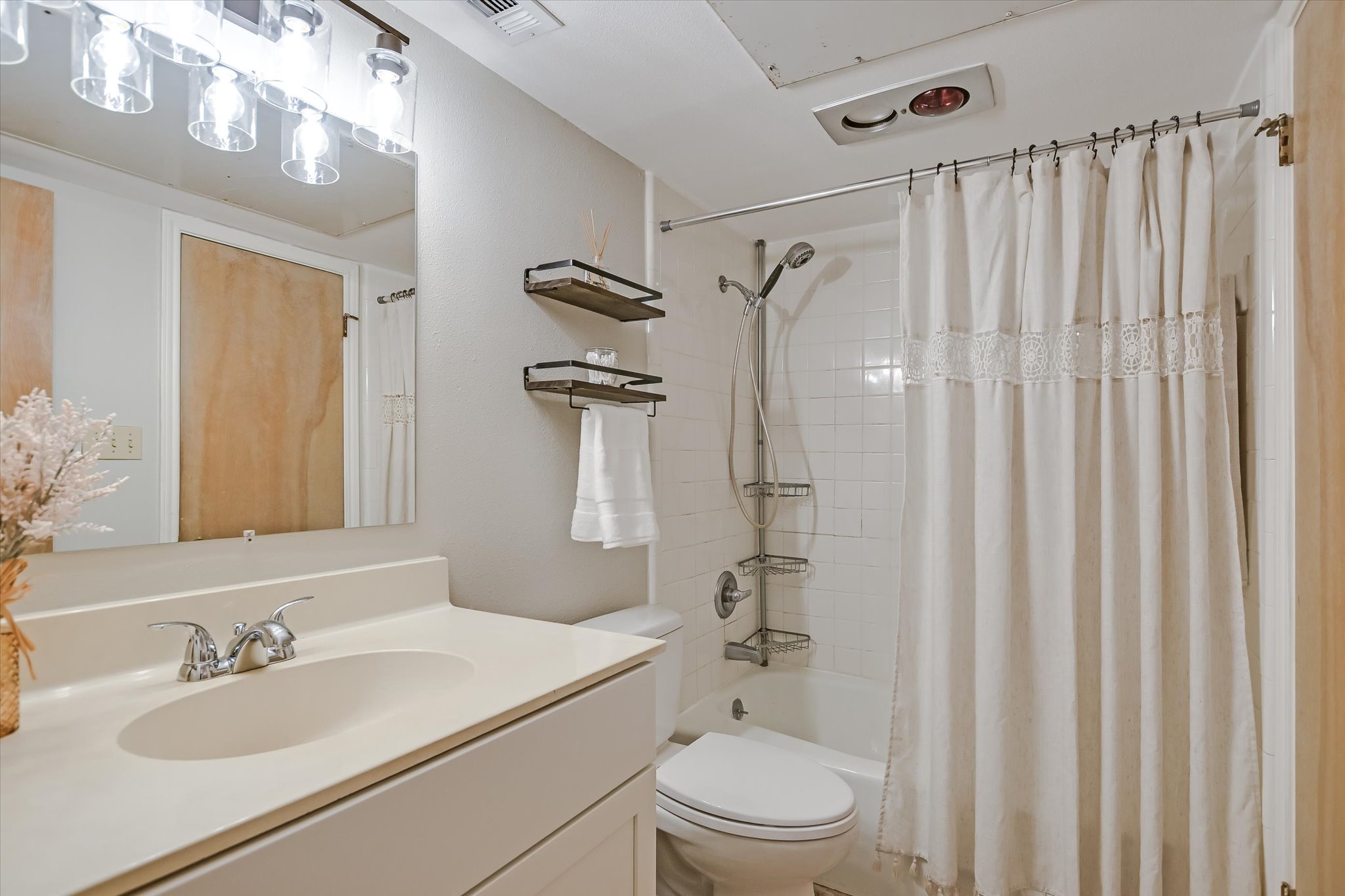 9226 Jollyville Road, Unit 122 Austin, TX 78759 - Photo 7 of 20 a bathroom with a sink a toilet and shower curtain