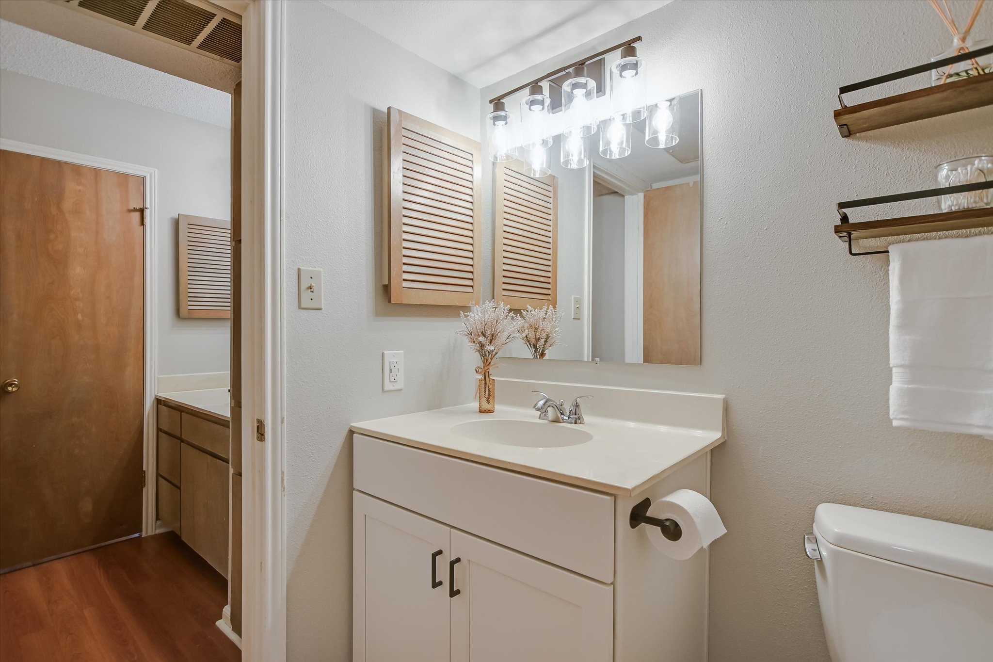 9226 Jollyville Road, Unit 122 Austin, TX 78759 - Photo 8 of 20 a bathroom with a sink a toilet and a mirror