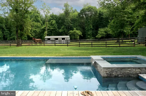 a view of a swimming pool with a yard