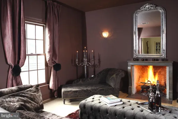 a living room with furniture and large windows